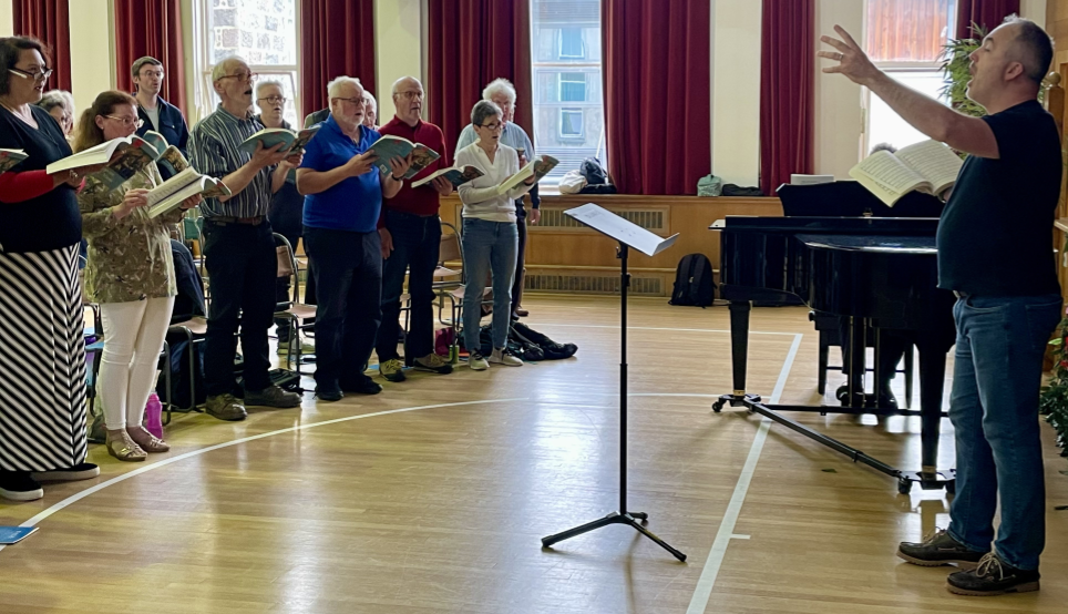 Sam Evans rehearsing at choral workshop in June 2024